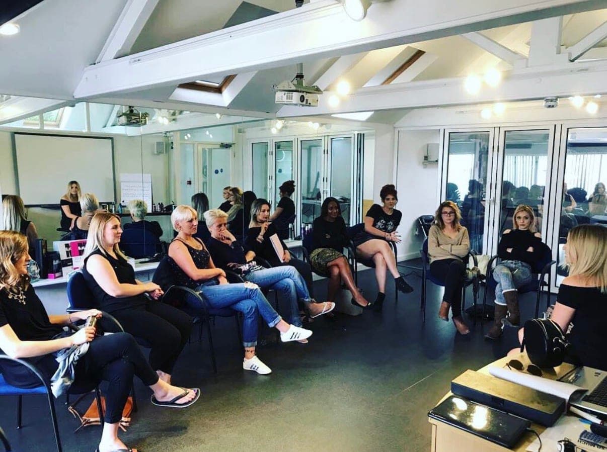 Amanda teaching a room of hairdressers at a professional session