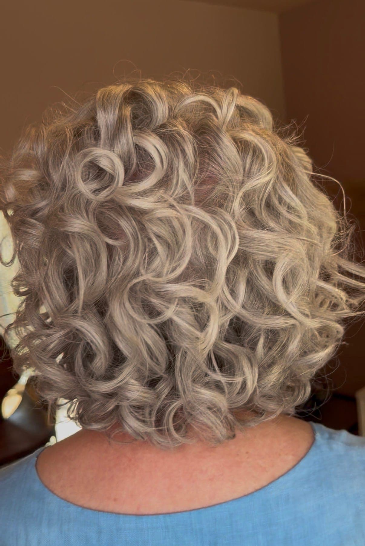 A silver curly bob full of shape and movement