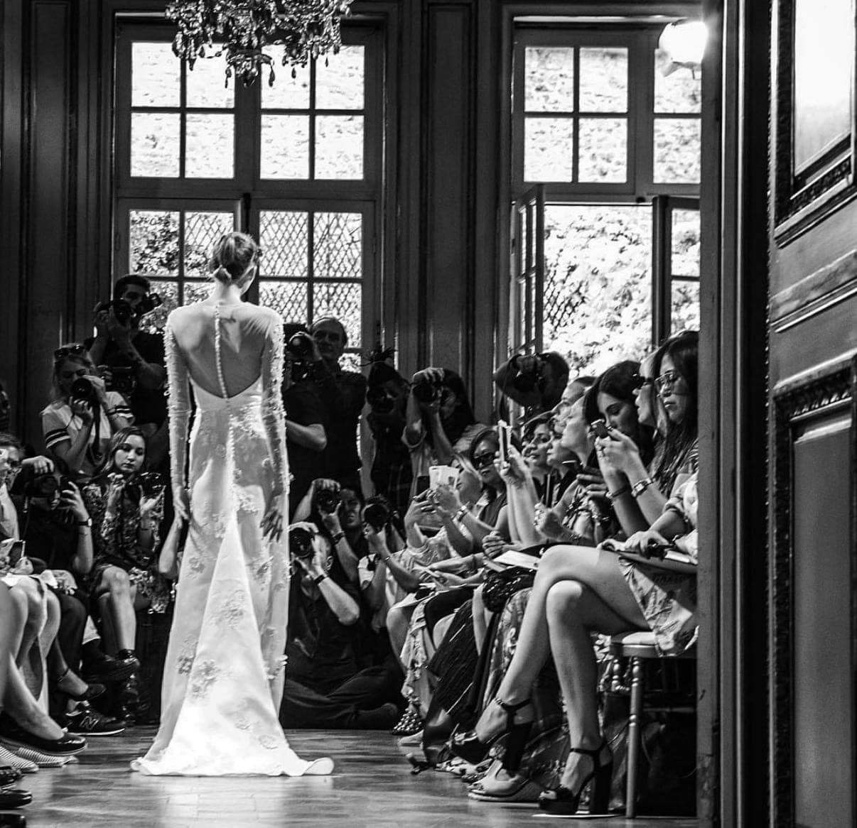 Backstage at a fashion show, photographed in black and white